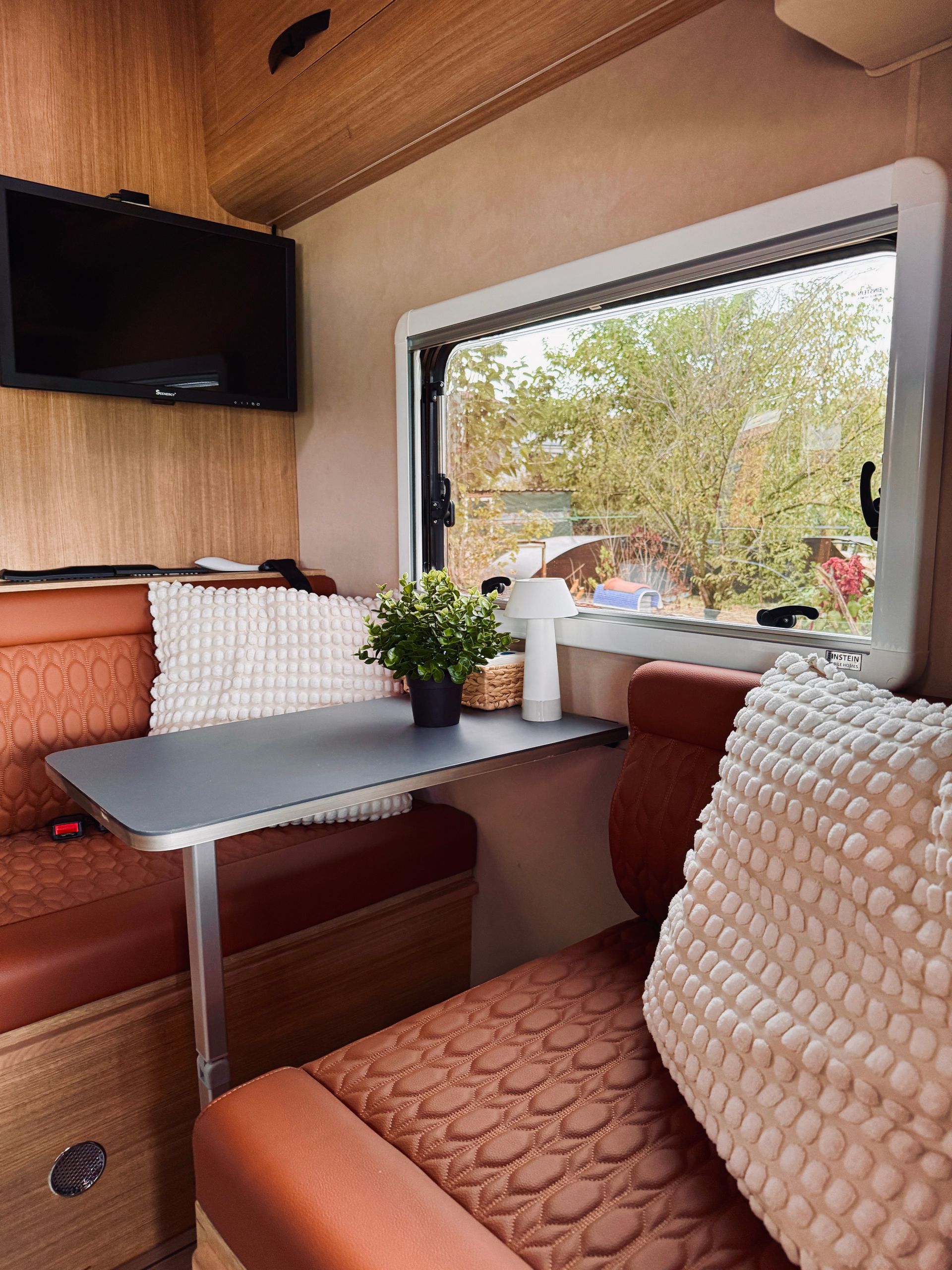 Modern renovated RV interior with lounge seating